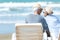 Asian Lifestyle senior couple sitting on the chair beach.  People old happy in love romantic and relax time on the sand beach.Â 